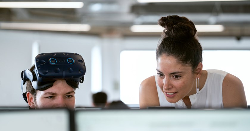 a male and a female engineer view data on a computer screen