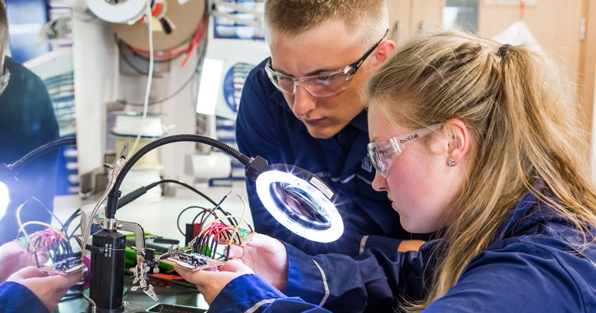 two young engineers working on electronic components in a laboratory